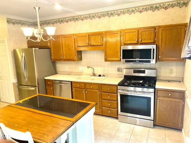 5500 Fortunes Ridge Dr Unit 82B, Durham, NC 27713 - kitchen featuring stainless steel appliances, a chandelier, brown cabinets, ornamental molding, and decorative backsplash