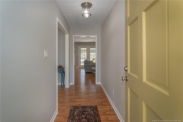 204 Bayfield Loop, Fayetteville, NC 28314 - hallway with light wood finished floors, baseboards, and a textured ceiling