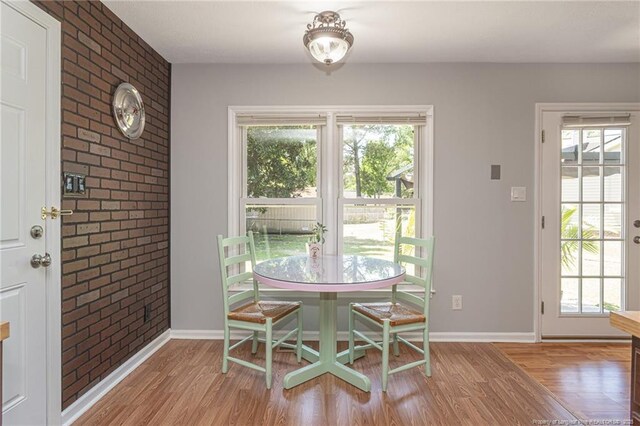 204 Bayfield Loop, Fayetteville, NC 28314 - dining space featuring healthy amount of natural light, wood finished floors, and brick wall