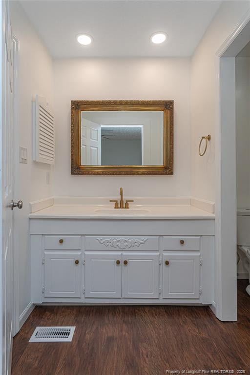 204 Bayfield Loop, Fayetteville, NC 28314 - bathroom with vanity, wood finished floors, toilet, and baseboards