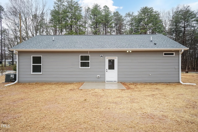 back of property with roof with shingles, a patio, and central AC unit