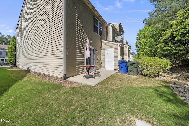 view of home's exterior with a yard and a patio