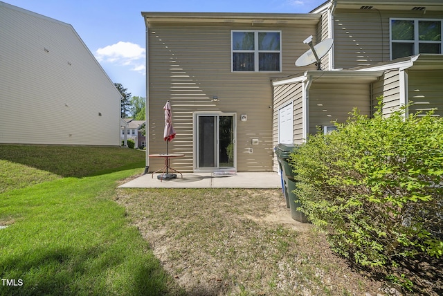 back of property with a lawn and a patio