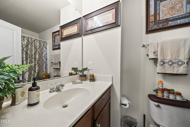 full bath featuring vanity and toilet