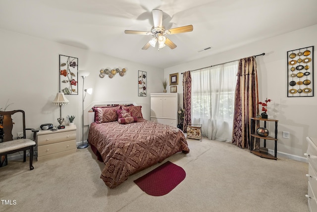 carpeted bedroom featuring visible vents and ceiling fan