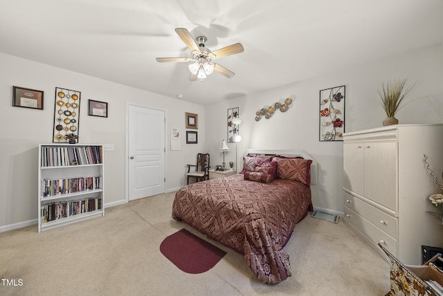 bedroom featuring baseboards, a ceiling fan, and carpet flooring