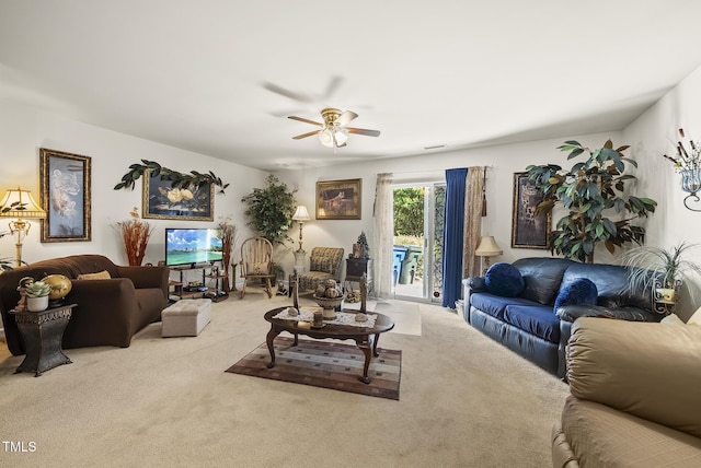 living area with carpet and a ceiling fan