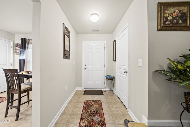 entryway featuring visible vents, baseboards, and light tile patterned flooring