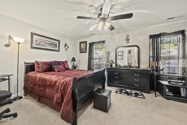 bedroom featuring ceiling fan, visible vents, and light carpet