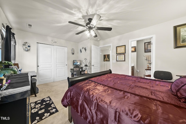 carpeted bedroom featuring a closet, a ceiling fan, and visible vents
