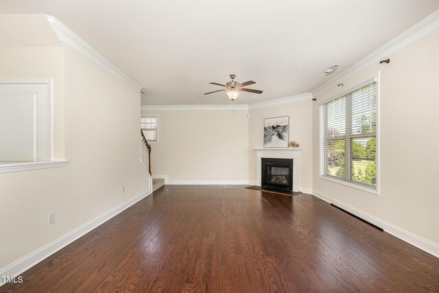 unfurnished living room featuring crown molding, a ceiling fan, plenty of natural light, and stairway