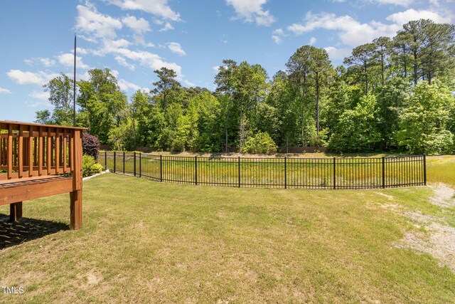 view of yard with fence and a deck