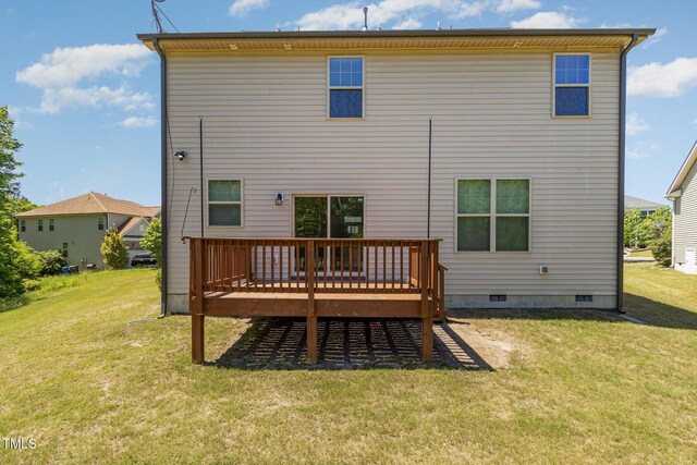 rear view of property featuring a yard, a deck, and crawl space