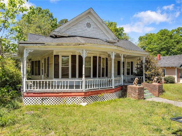 107 Church St, Red Springs, NC 28377 - rear view of property with a lawn, a shingled roof, and covered porch