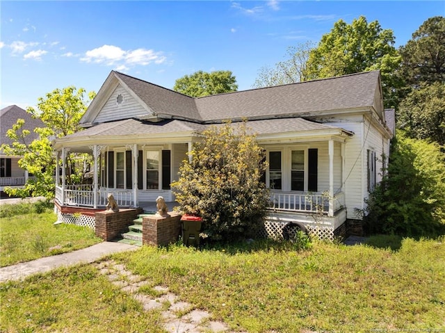 107 Church St, Red Springs, NC 28377 - view of front facade featuring a porch, a shingled roof, and a front lawn
