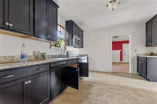 107 Church St, Red Springs, NC 28377 - kitchen featuring stainless steel microwave, light stone countertops, black dishwasher, and a sink