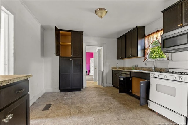 107 Church St, Red Springs, NC 28377 - kitchen featuring dark brown cabinets, white gas range oven, baseboards, and stainless steel microwave