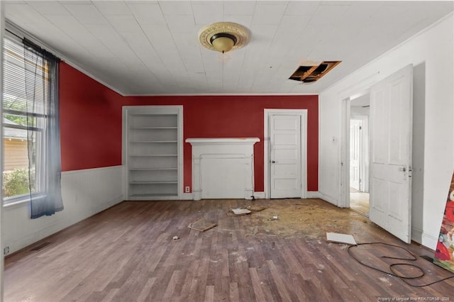 107 Church St, Red Springs, NC 28377 - interior space with visible vents, a wainscoted wall, wood finished floors, and ornamental molding