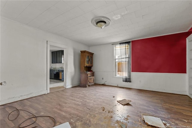 107 Church St, Red Springs, NC 28377 - unfurnished living room featuring a wainscoted wall and wood finished floors
