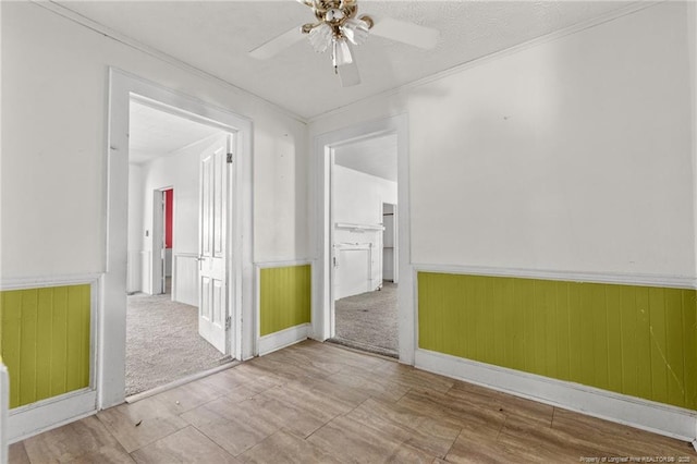 107 Church St, Red Springs, NC 28377 - spare room with wainscoting, a ceiling fan, and ornamental molding