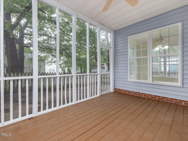 unfurnished sunroom with ceiling fan