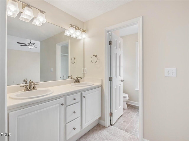 bathroom featuring toilet, double vanity, ceiling fan, and tile patterned floors