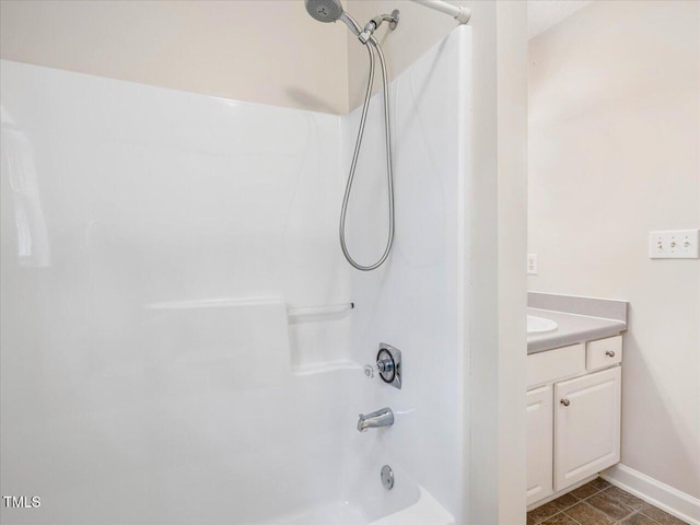 full bath featuring baseboards, shower / tub combination, and vanity