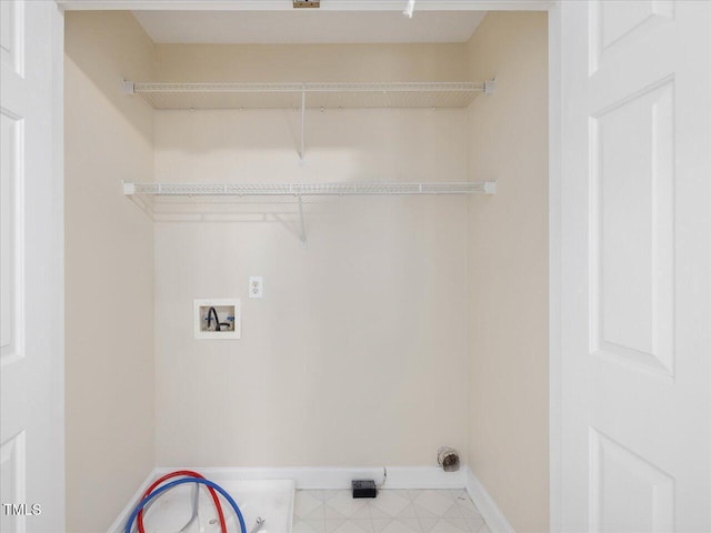 laundry area featuring hookup for a washing machine and baseboards
