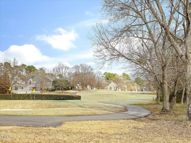 view of home's community with a lawn and a residential view
