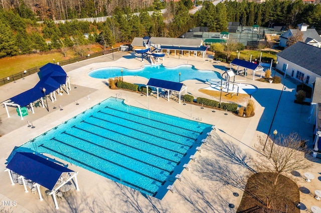 community pool featuring fence and a patio area