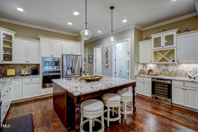 kitchen featuring wine cooler, appliances with stainless steel finishes, white cabinets, and backsplash