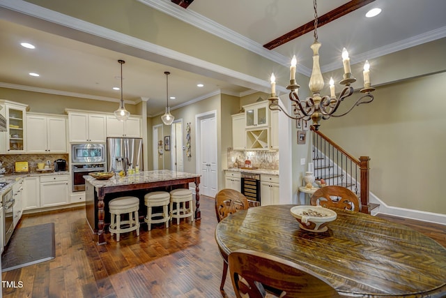 dining area featuring dark wood-style flooring, beverage cooler, and recessed lighting