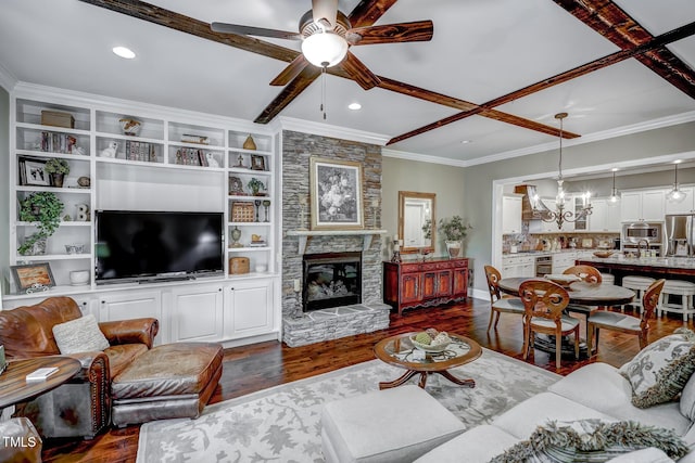 living area with recessed lighting, dark wood-style flooring, ceiling fan with notable chandelier, and a stone fireplace