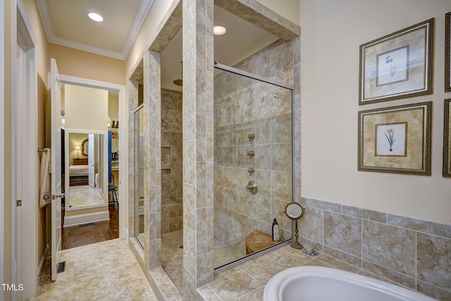 bathroom featuring ornamental molding, a shower stall, and a bath