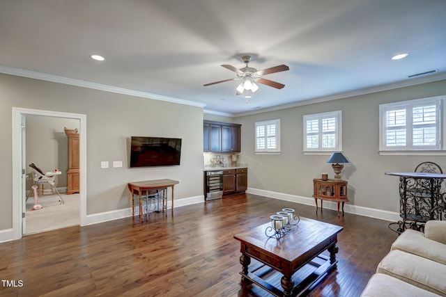 living room featuring a ceiling fan, visible vents, a wealth of natural light, and beverage cooler