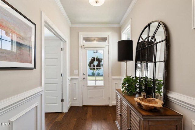 entryway featuring ornamental molding, a wainscoted wall, and dark wood-type flooring