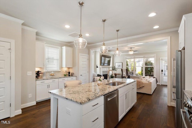kitchen with ceiling fan, appliances with stainless steel finishes, a sink, dark wood-style floors, and open floor plan
