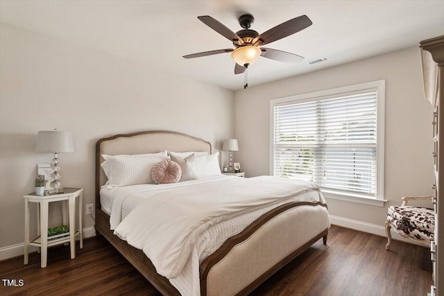 bedroom with a ceiling fan, baseboards, visible vents, and wood finished floors