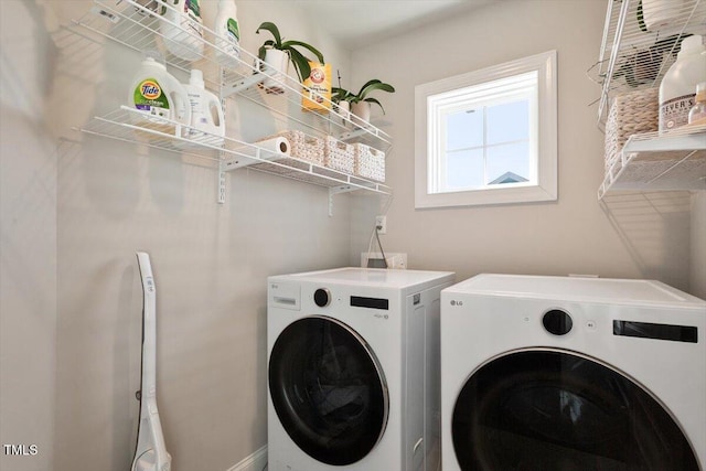 laundry room with laundry area and washing machine and clothes dryer