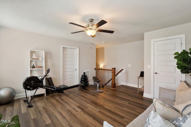 workout room featuring baseboards, ceiling fan, and wood finished floors