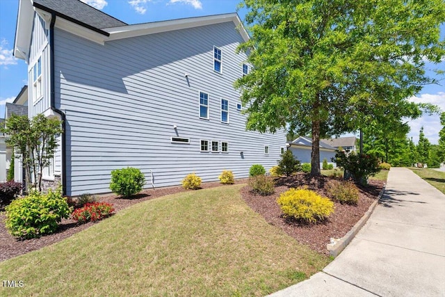 view of side of home featuring a yard