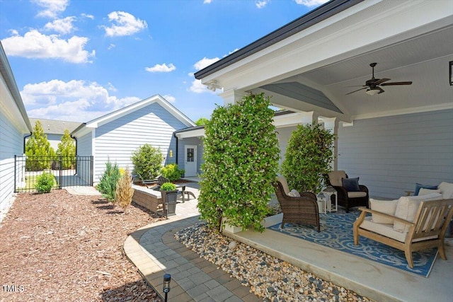 view of patio / terrace featuring fence and ceiling fan