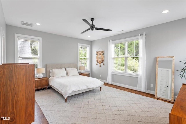 bedroom with recessed lighting, wood finished floors, ceiling fan, baseboards, and visible vents