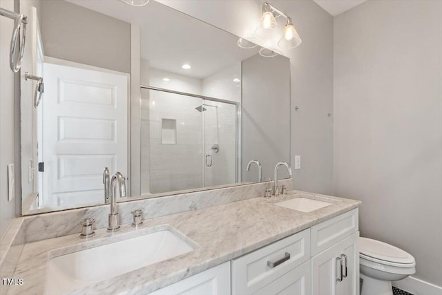 full bath featuring toilet, a stall shower, double vanity, and a sink