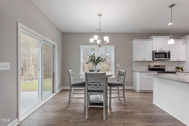 3803 Huntcliff Dr, La Grange, NC 28551 - dining space featuring a chandelier, light wood finished floors, and baseboards