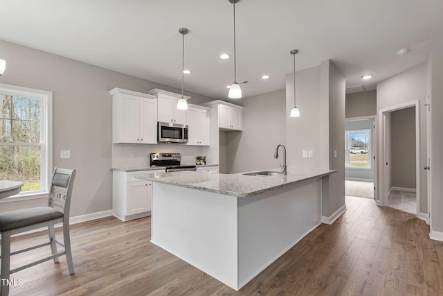 3803 Huntcliff Dr, La Grange, NC 28551 - kitchen with a sink, stainless steel appliances, white cabinets, light wood-type flooring, and recessed lighting