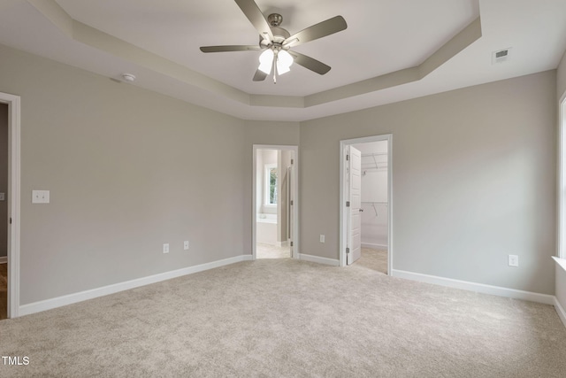 3803 Huntcliff Dr, La Grange, NC 28551 - unfurnished bedroom featuring a raised ceiling, a spacious closet, light colored carpet, and baseboards