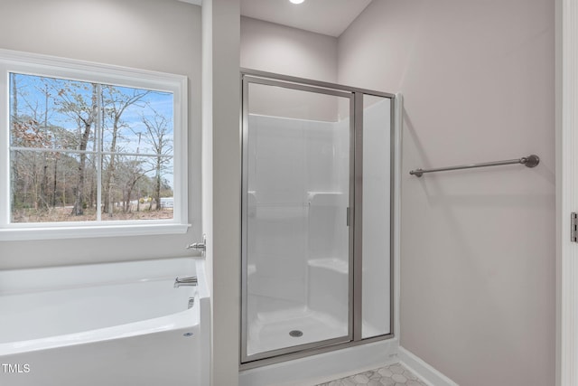 3803 Huntcliff Dr, La Grange, NC 28551 - full bathroom featuring a stall shower, a bath, baseboards, and tile patterned floors