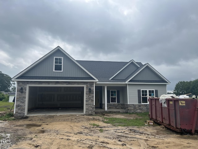 3803 Huntcliff Dr, La Grange, NC 28551 - view of front of house with covered porch, stone siding, a garage, and driveway