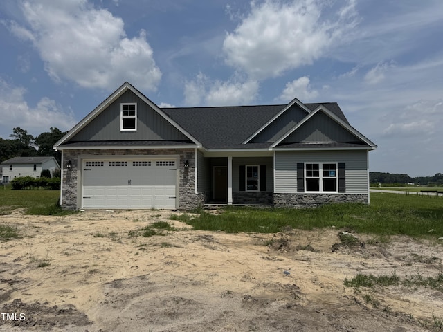 3803 Huntcliff Dr, La Grange, NC 28551 - craftsman house featuring stone siding, a garage, a shingled roof, and driveway